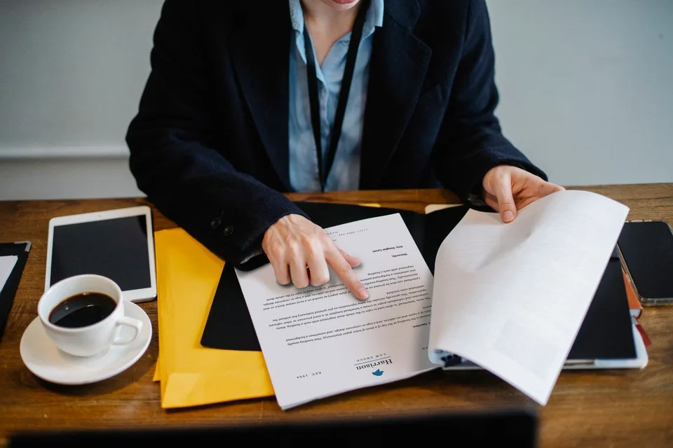 Documents being reviewed at a table; editorial photograph